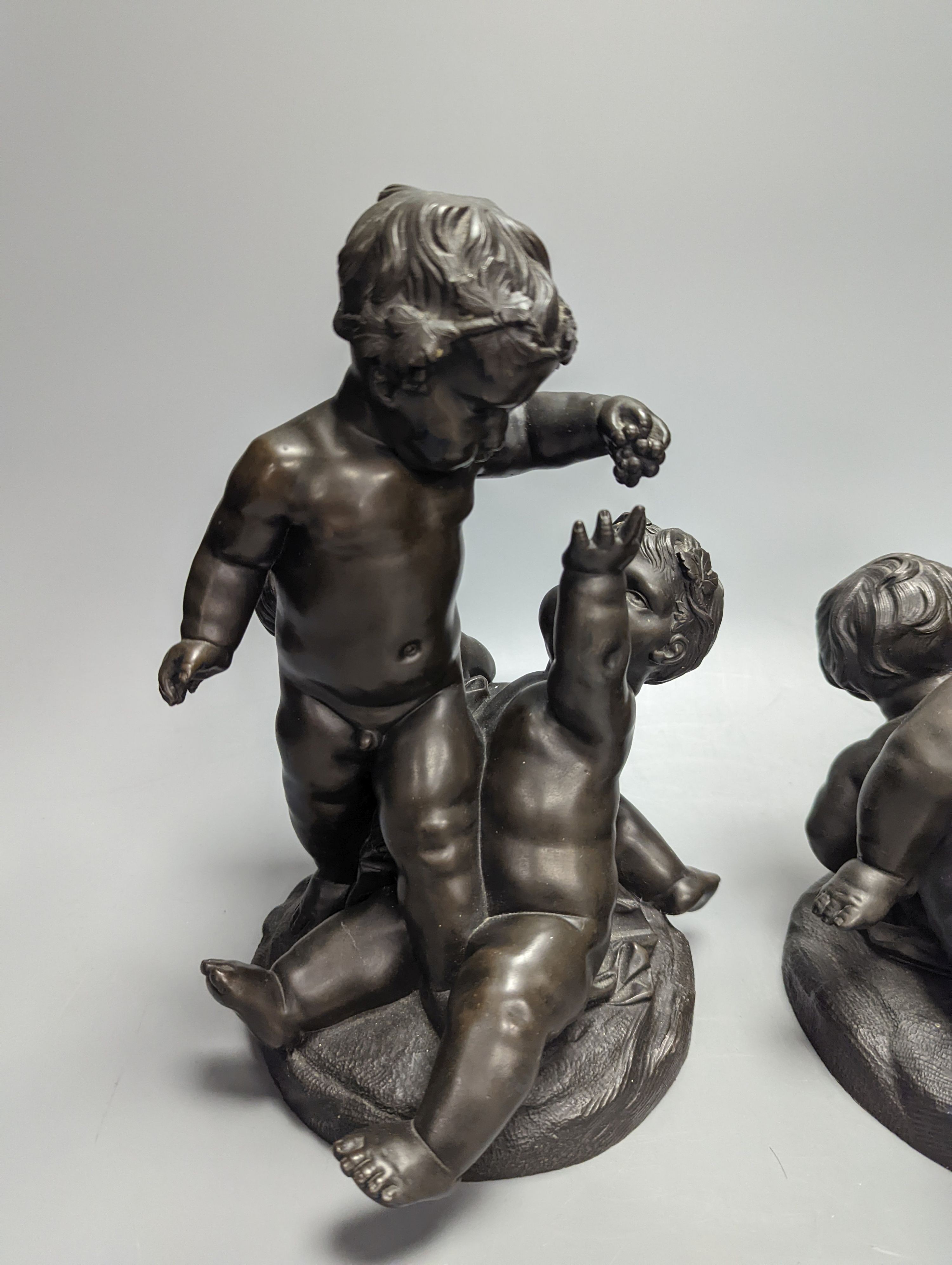 After Clodion, a pair of early 20th century bronze groups of putto, tallest 25cm